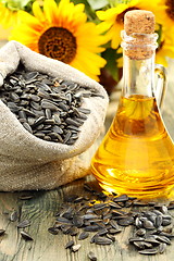 Image showing Sunflower seeds in bag and bottle of oil.