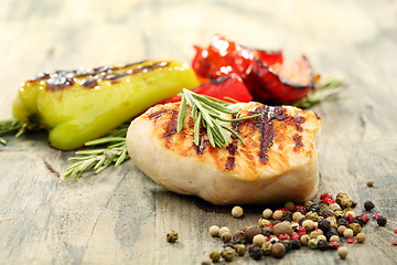 Image showing Turkey steak with rosemary and baked peppers.