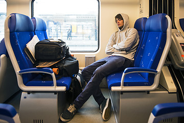 Image showing Young Man Sleeping In Train