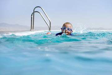 Image showing Boy Swimming In an Infinity Pool 