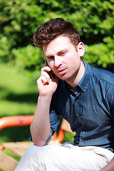 Image showing Young man at telephone in nature