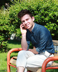 Image showing Relaxed handsome man in park calling