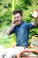 Image showing Very happy man at telephone in park