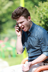 Image showing Young man angry on telephone