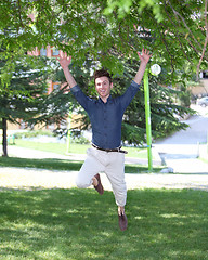 Image showing Happy and jumping young man in park