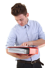 Image showing Young man checking documents