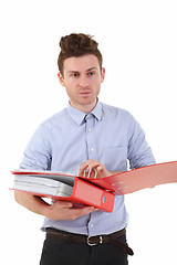 Image showing Young man holding folders