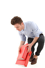 Image showing Young employee with falling folders