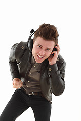 Image showing Young adult male louding and listening music