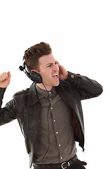 Image showing Young adult male louding and listening music