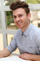 Image showing Young adult man writing note