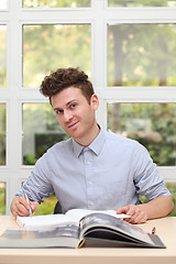 Image showing Young adult man writing note