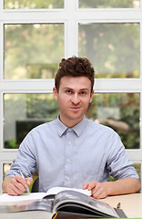 Image showing Young adult man writing note