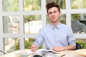 Image showing Young adult man writing note