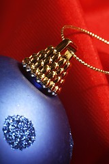 Image showing Blue xmas ball on red