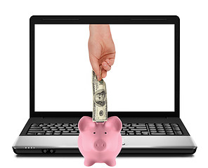 Image showing Laptop with piggy bank and hundred dollar