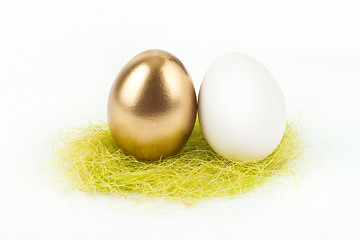 Image showing A gold egg with white egg