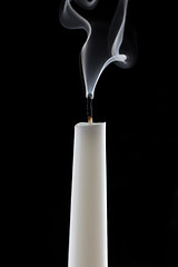 Image showing extinguished candle with smoke, isolated over black