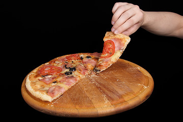 Image showing Pizza and slice of pizza in hand