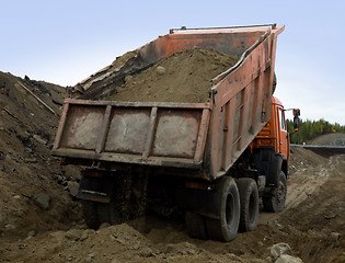 Image showing A dump truck is dumping gravel 