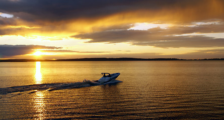 Image showing The motorboat tour. Sunset on the lake.