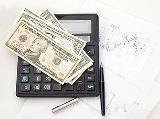 Image showing Chart, calculator, pen and dollars.