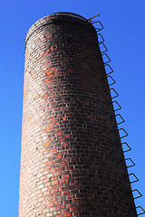 Image showing old brick chimney on blue sky 