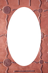 Image showing textures on wall and white oval in center 