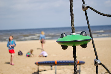 Image showing Kids in playground near sea. Climb toys equipment 