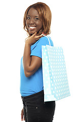 Image showing Satisfied lady shopper with shopping bag