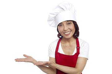 Image showing Smiling asian chef gesturing guests to take their seats