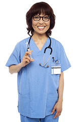 Image showing Experienced female pediatrician ready with a syringe