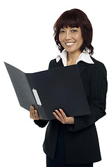 Image showing Secretary holding opened binder, smiling