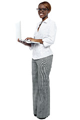 Image showing African businesswoman working on laptop