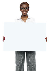Image showing Female business executive holding blank billboard