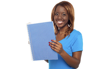 Image showing Smiling college student holding notebook