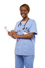 Image showing Female surgeon writing medical prescription