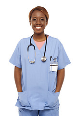 Image showing Relaxed female surgeon posing with hands in her coat