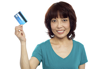 Image showing Beautiful woman holding her credit card out