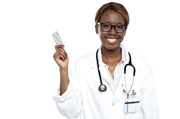 Image showing Female doctor holding pack of medicine