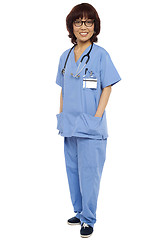 Image showing Asian surgeon posing with hands in her uniform