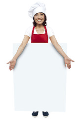 Image showing Full length portrait of young chef presenting billboard