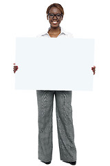 Image showing Corporate woman holding blank white billboard