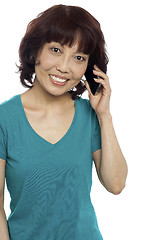 Image showing Pretty female communicating through cellphone