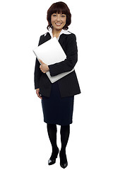 Image showing Female executive posing with laptop, full length shot