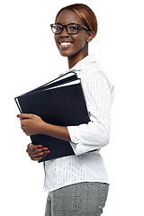 Image showing Female secretary carrying office files