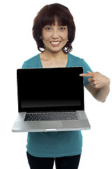 Image showing Saleswoman presenting you brand new laptop