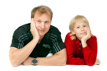 Image showing Dad and son lying on the floor in the studio