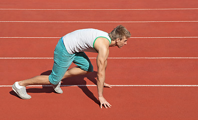 Image showing Young man preparing to run