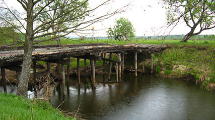 Image showing Old almost destroyed bridge across river